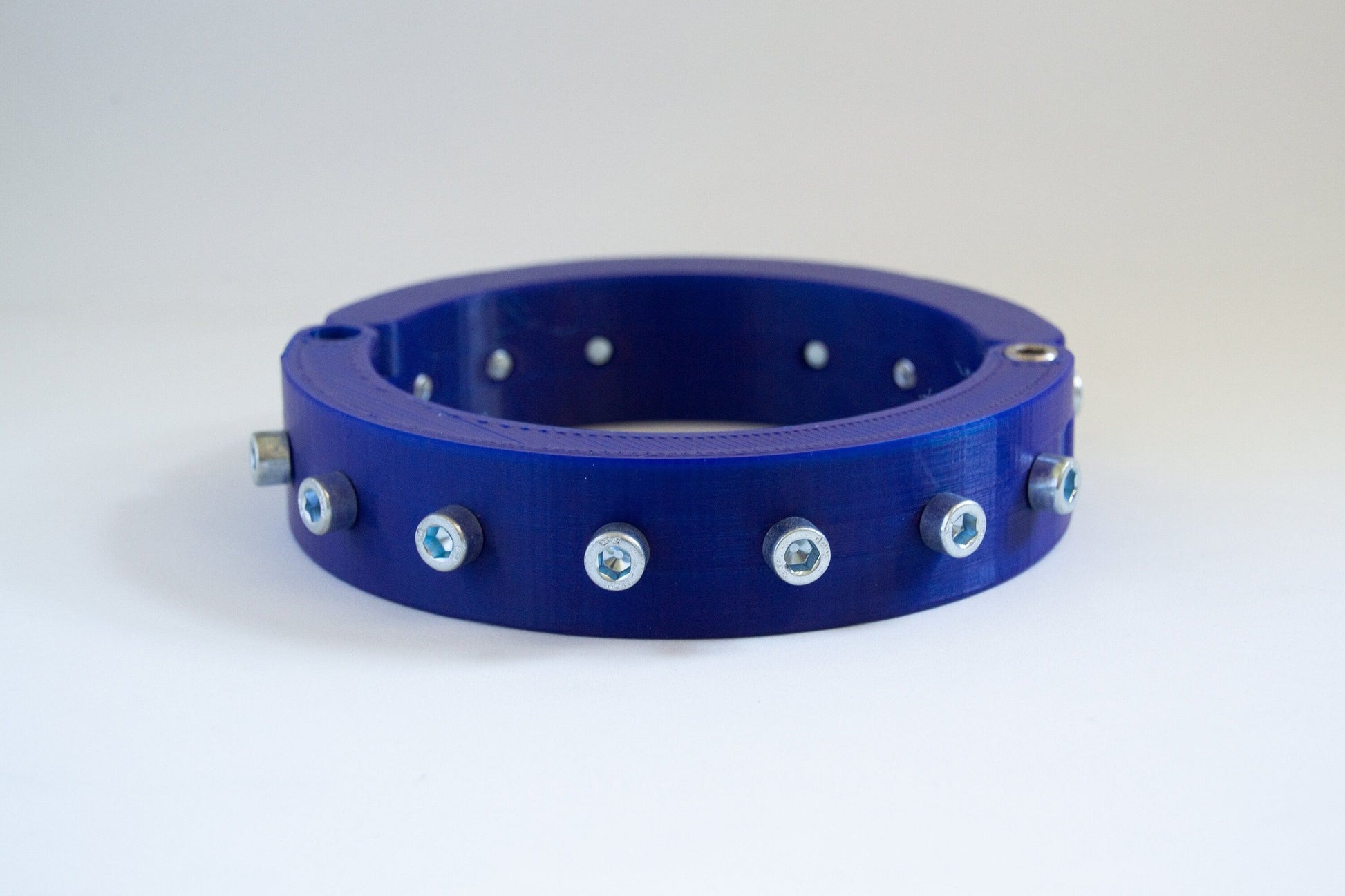 Blue 3d printed bdsm collar adorned with bolts from the side