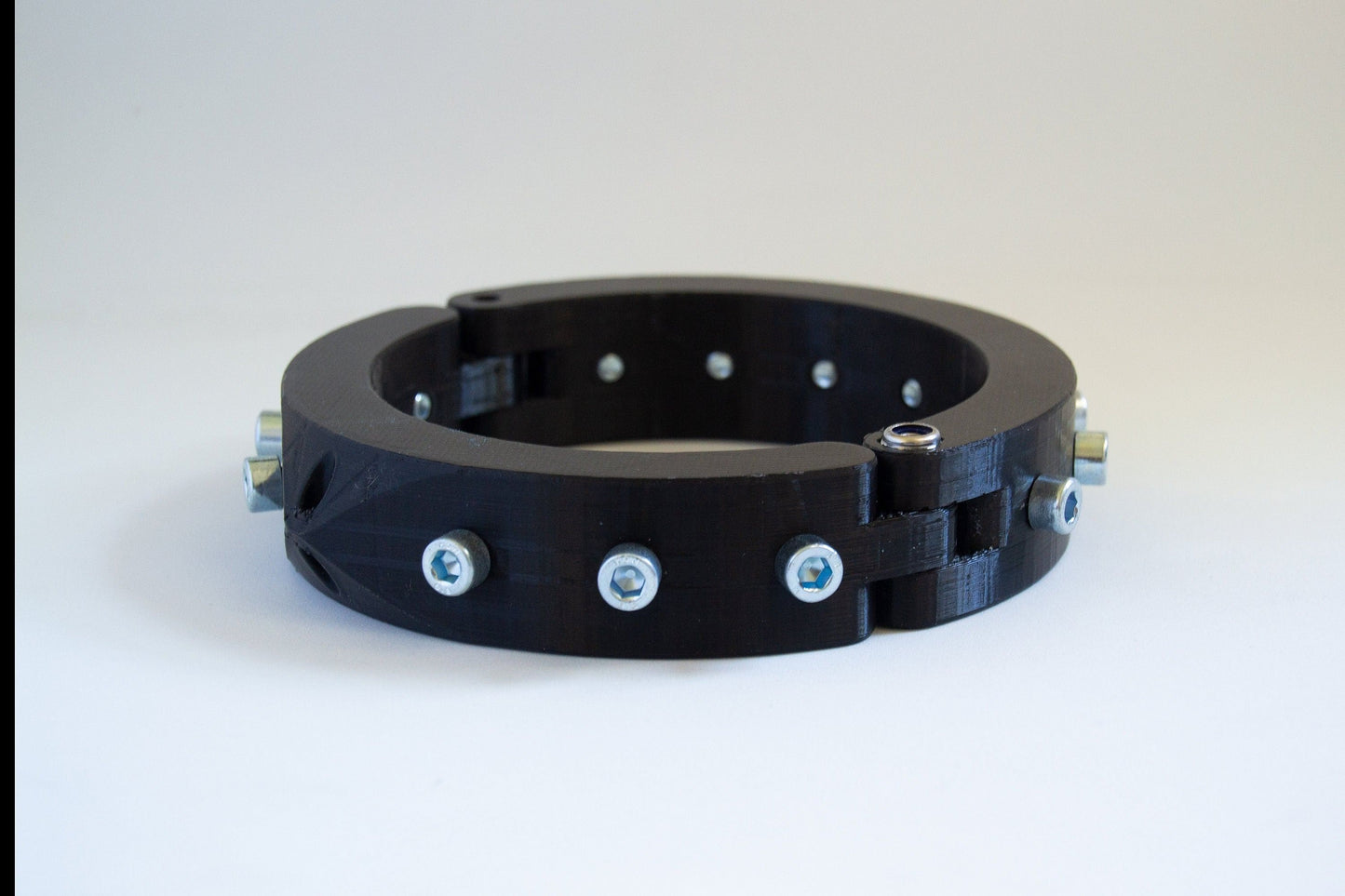Black 3d printed bdsm collar adorned with bolts