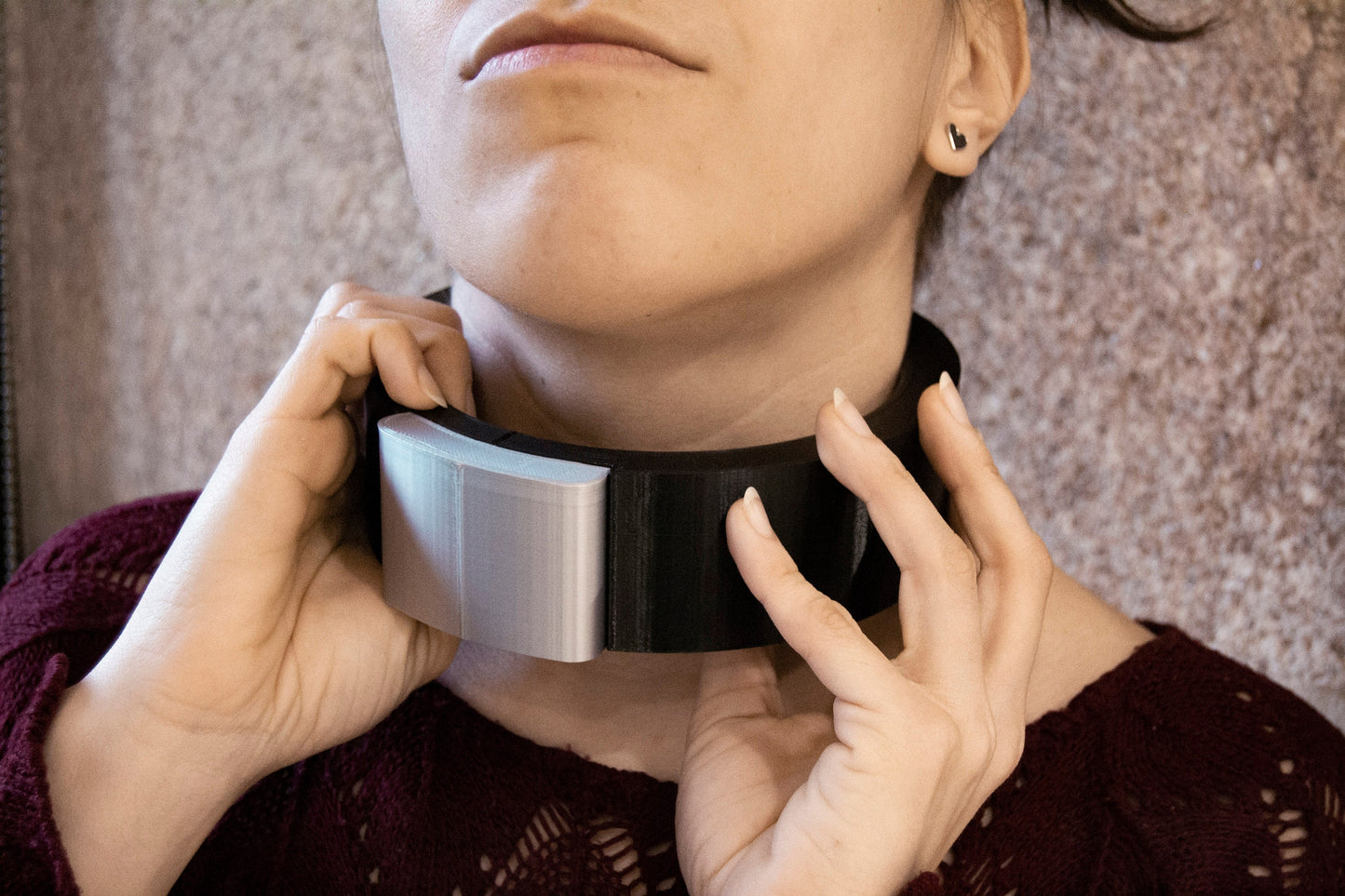woman holding sleek nordic collar featuring a silver fastener